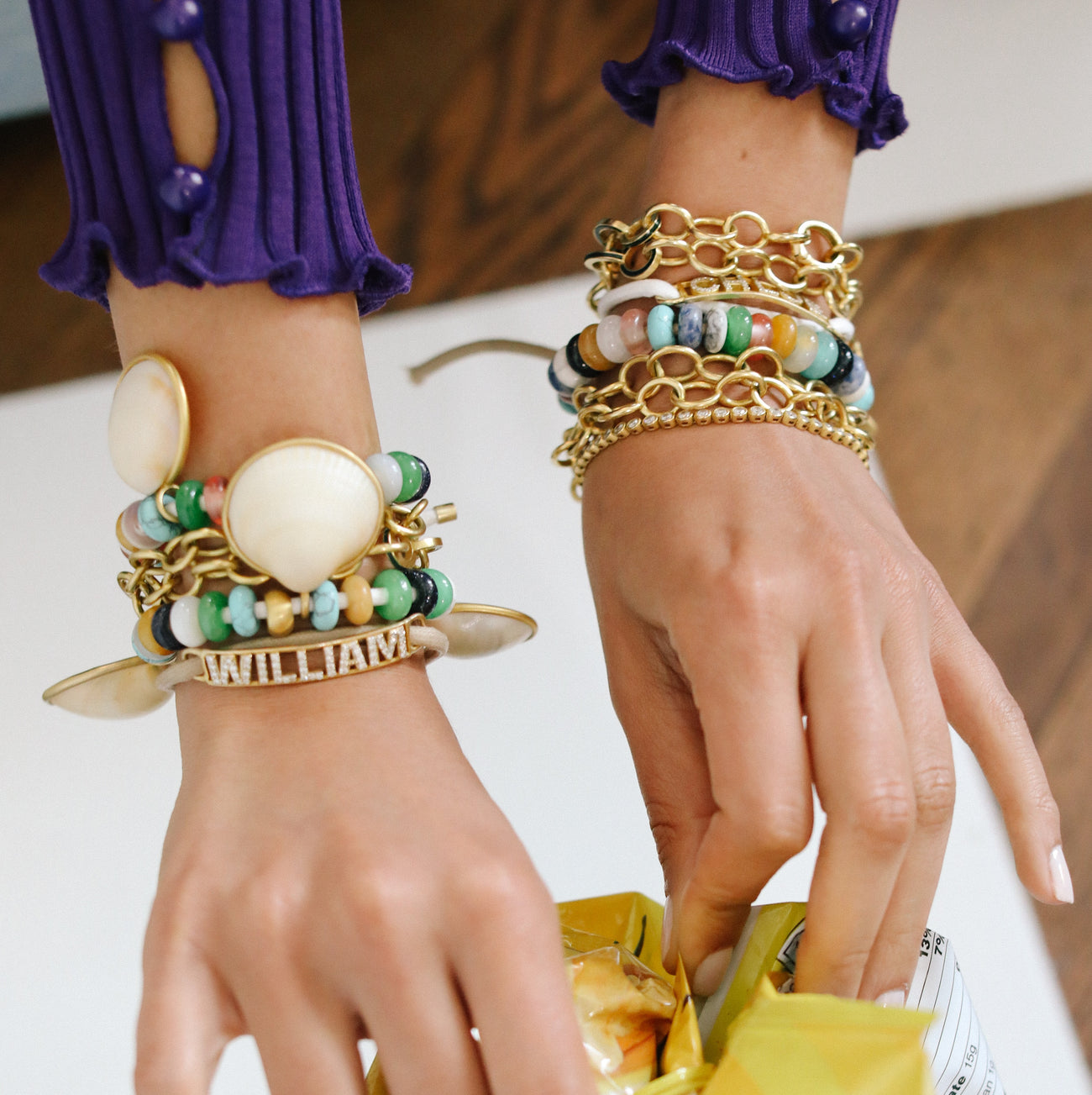 styled bracelets on wrists hands opening a bag of chips