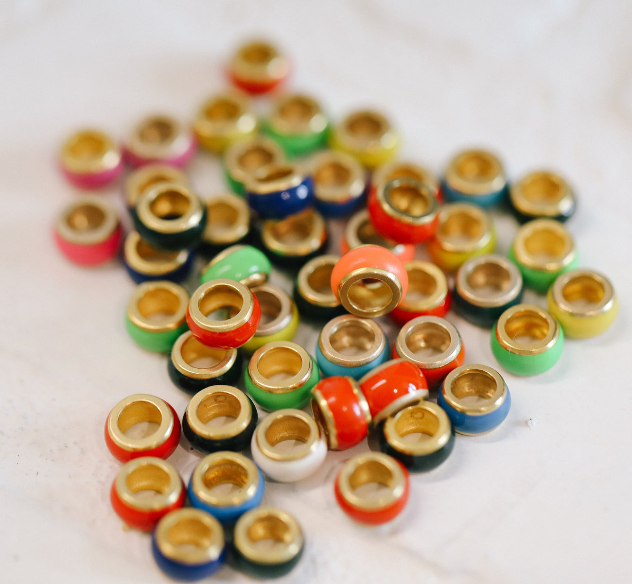 assorted color enamel and gold rondels